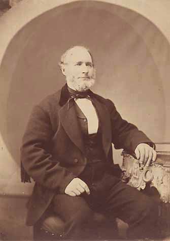 Old Man Seated Next to a Table