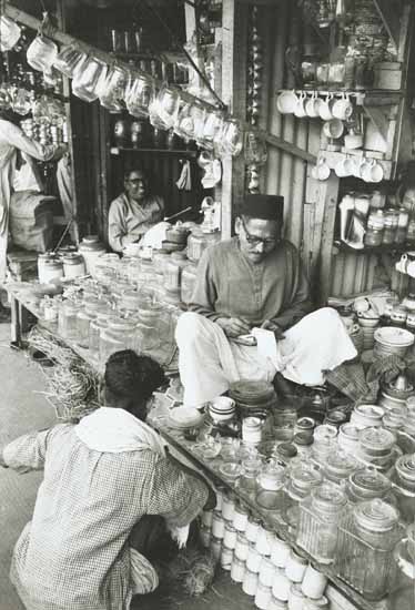 Anonymous - Indian Merchant Totals up Sales in a Kitchen Wares Store